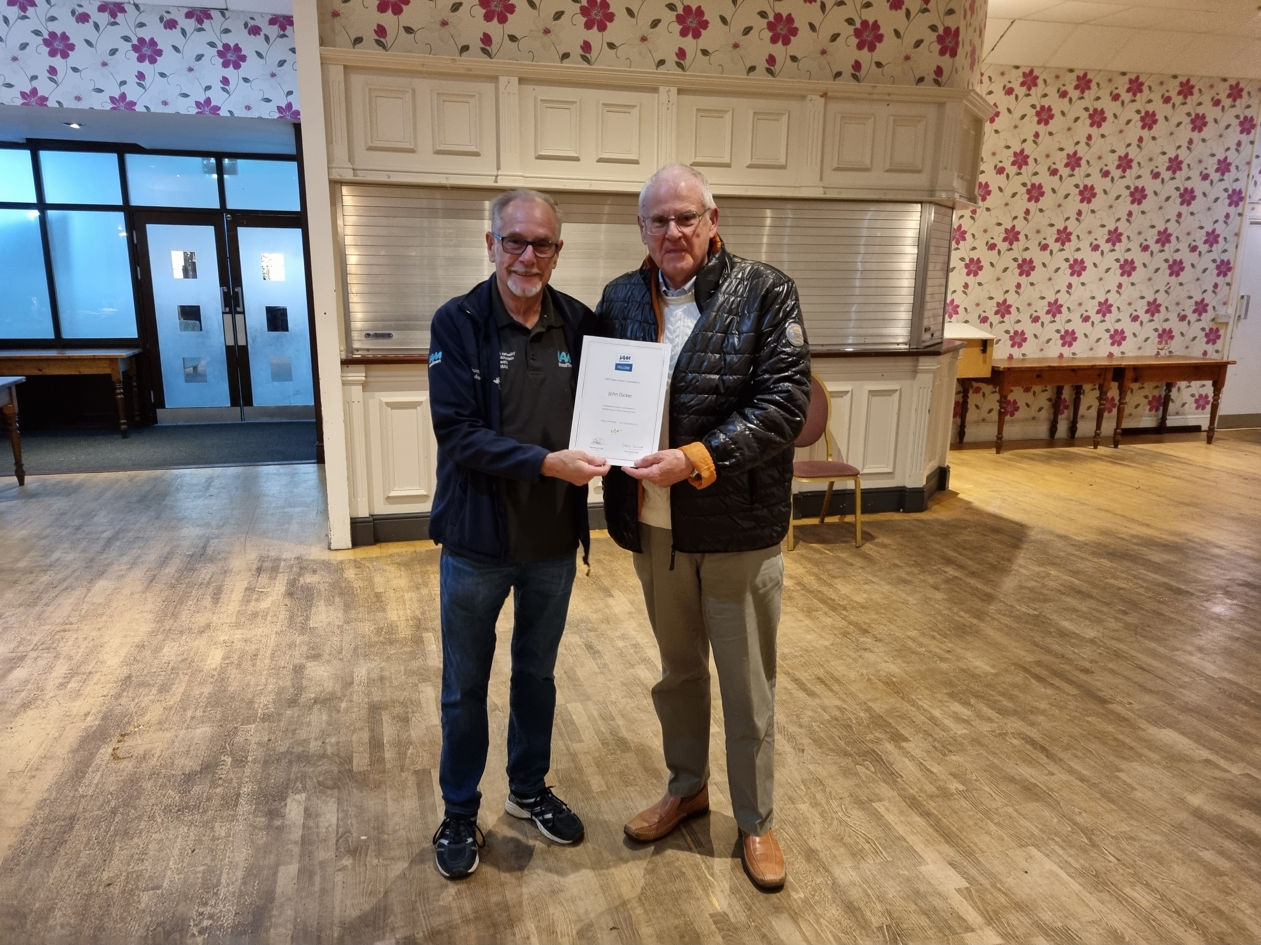 Terry heath presented John Dicker with his certificate for passing his fellows Advanced driving test with a first category